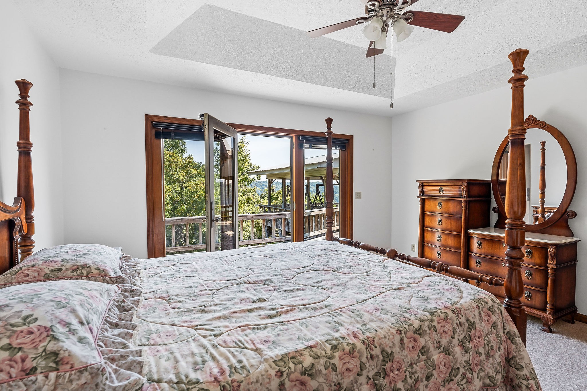 309 Cedar Hill Road Celina, TN 38551 - Photo 34 of 60 a bedroom with a large bed and a chandelier