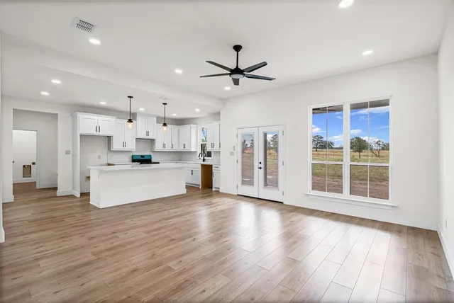 a view of kitchen with granite countertop a stove top oven a sink and a counter top space