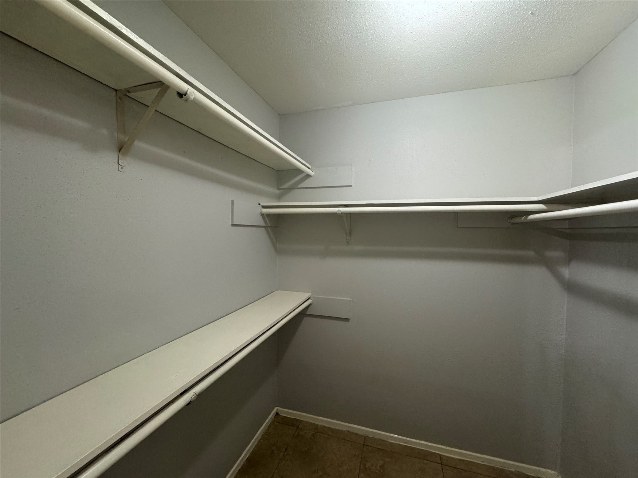 13327 Reads Court Houston, TX 77015 - Photo 10 of 17 a view of a room with racks on the wall