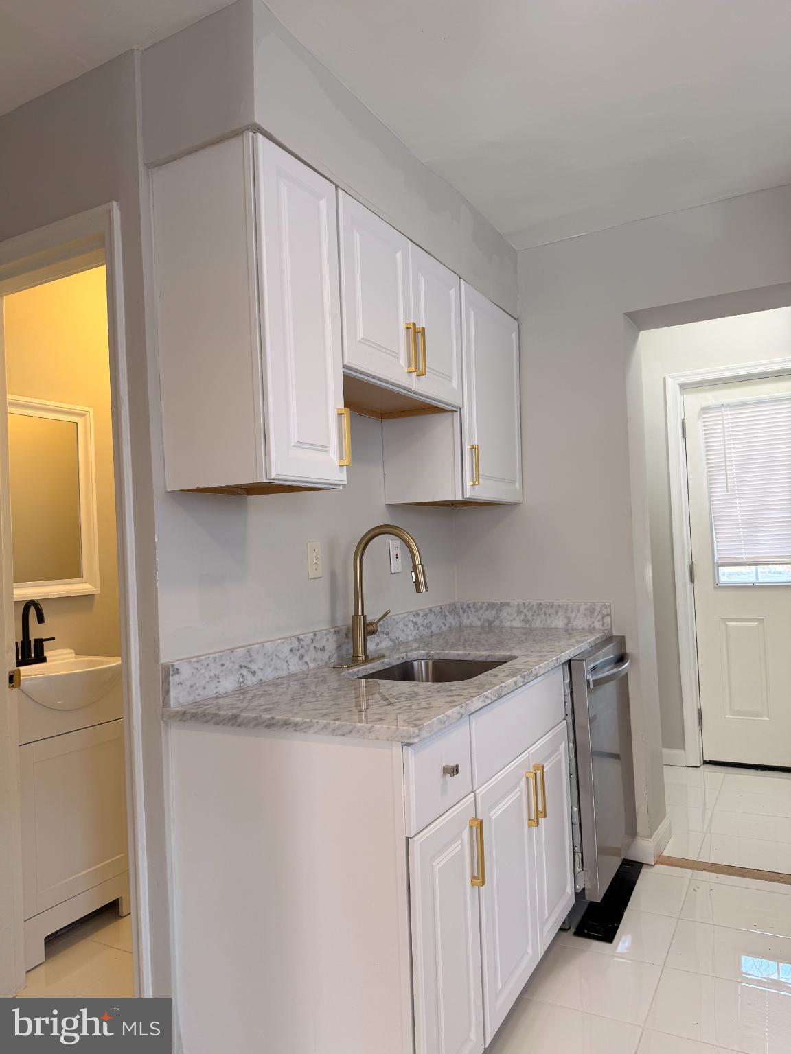 41 Tuckerman Street Northwest Washington, DC 20011 - Photo 15 of 49 a kitchen with stainless steel appliances granite countertop a sink and a stove next to a window