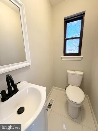 a bathroom with a sink a toilet and mirror