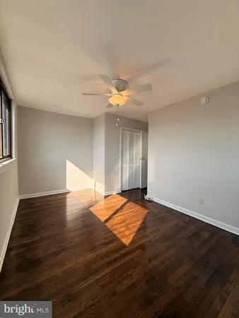 a view of an empty room and wooden floor