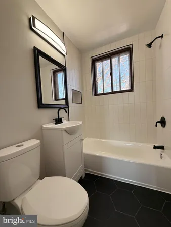 a bathroom with a toilet a sink and bathtub