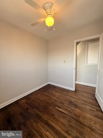 a view of an empty room and wooden floor