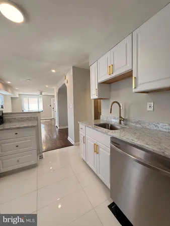 a kitchen with stainless steel appliances granite countertop a sink and cabinets