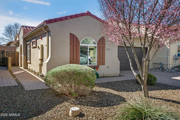 a front view of a house with garden