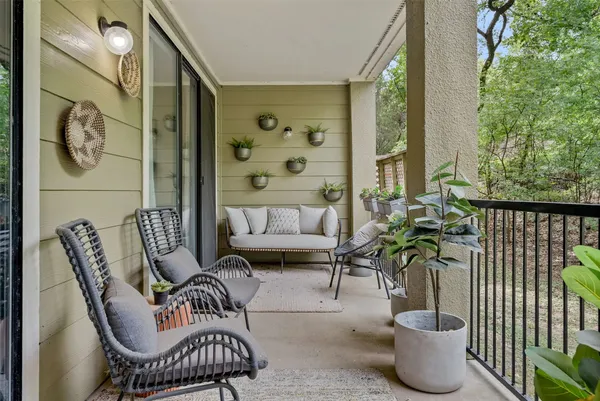 a view of a patio with table and chairs under an umbrella
