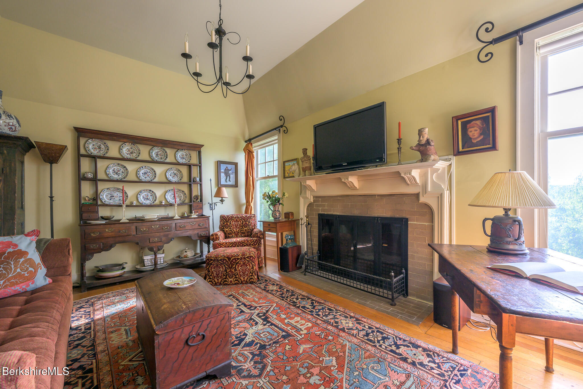 11 Prospect Hill Road, Unit F Stockbridge, MA 01262 - Photo 22 of 51 a living room with furniture a flat screen tv and a fireplace