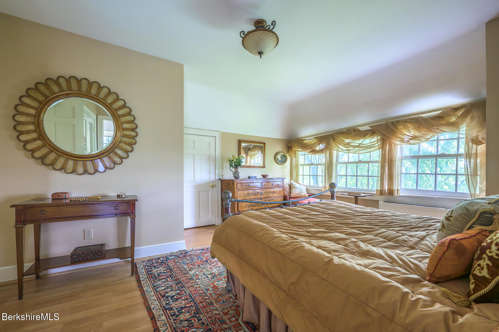 11 Prospect Hill Road, Unit F Stockbridge, MA 01262 - Photo 37 of 51 a bed sitting in a bedroom next to a window