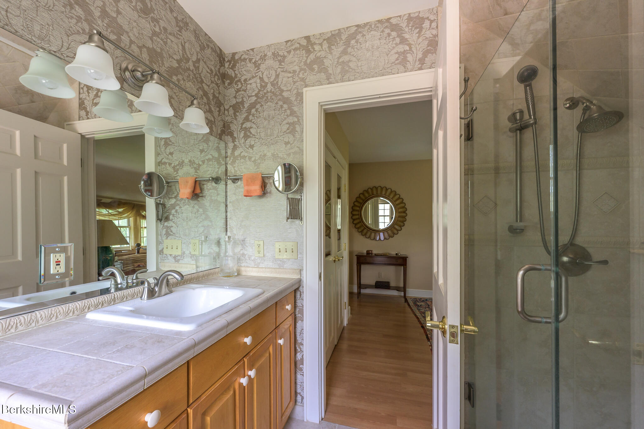 11 Prospect Hill Road, Unit F Stockbridge, MA 01262 - Photo 40 of 51 a bathroom with a granite countertop sink a mirror and a shower
