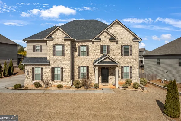 a front view of a house with a yard