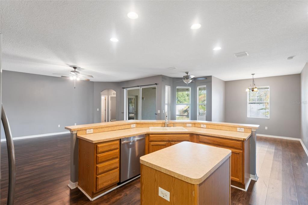 14027 Bensbrook Drive Spring Hill, FL 34609 - Photo 20 of 61 a kitchen that has a sink a stove and a table in it