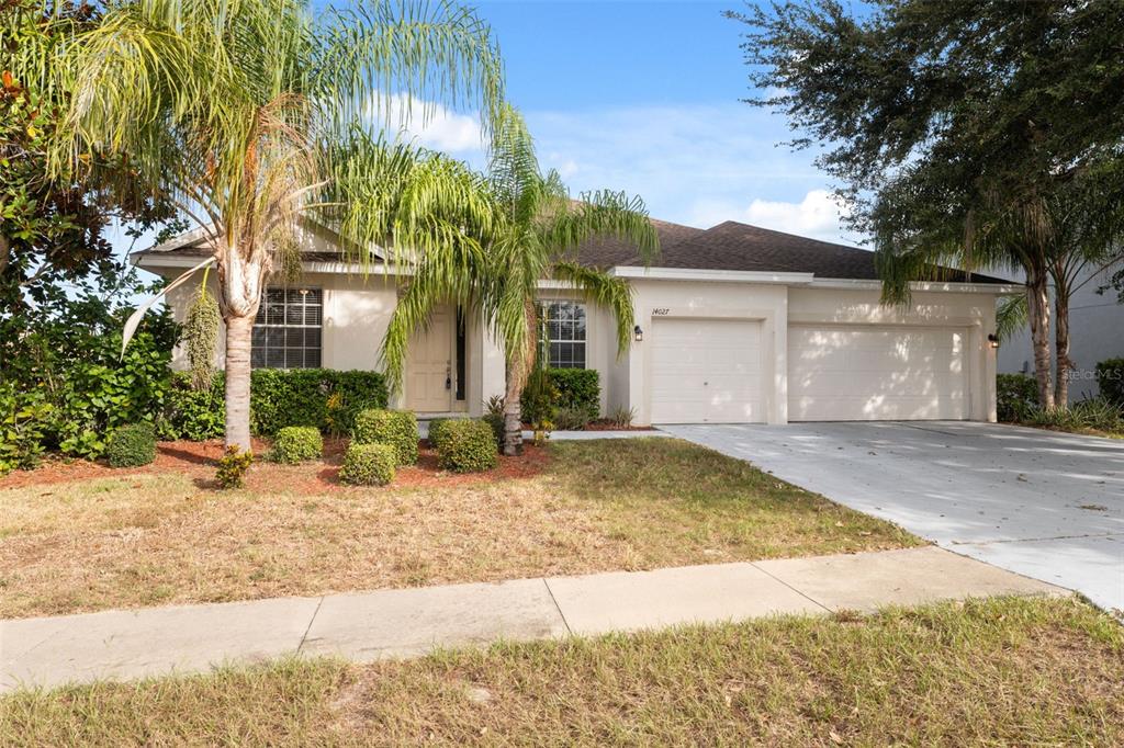14027 Bensbrook Drive Spring Hill, FL 34609 - Photo 2 of 61 a front view of a house with a yard and garage