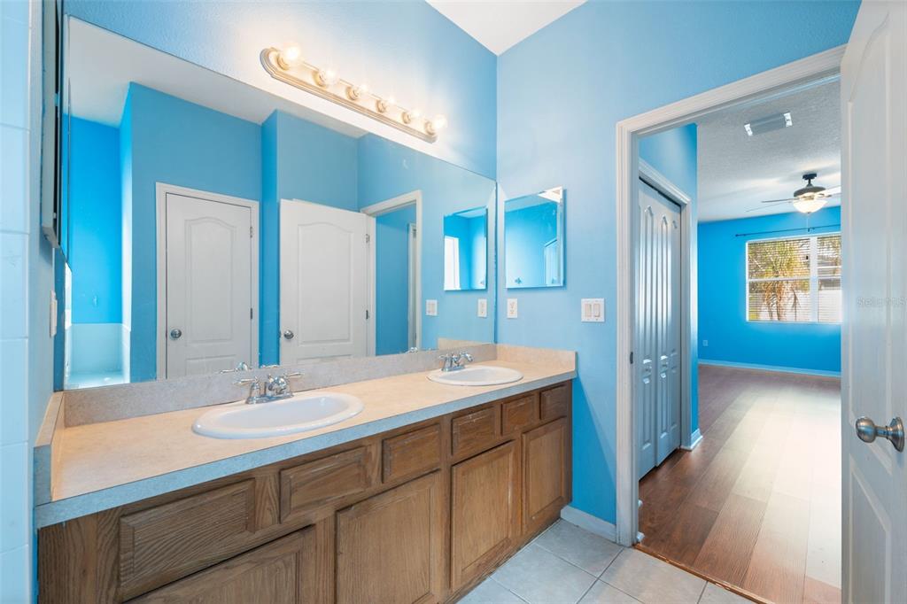 14027 Bensbrook Drive Spring Hill, FL 34609 - Photo 27 of 61 a bathroom with a double vanity sink and a mirror