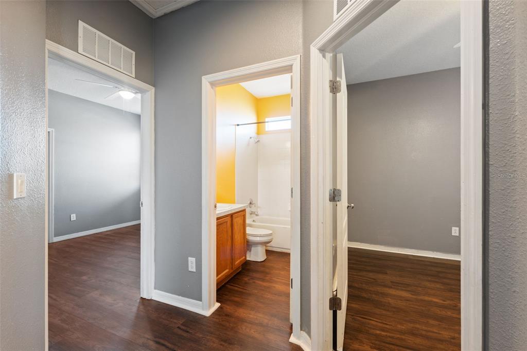 14027 Bensbrook Drive Spring Hill, FL 34609 - Photo 28 of 61 a view of an empty room with wooden floor and a window