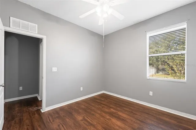 a bathroom with a bathtub shower sink vanity mirror and toilet