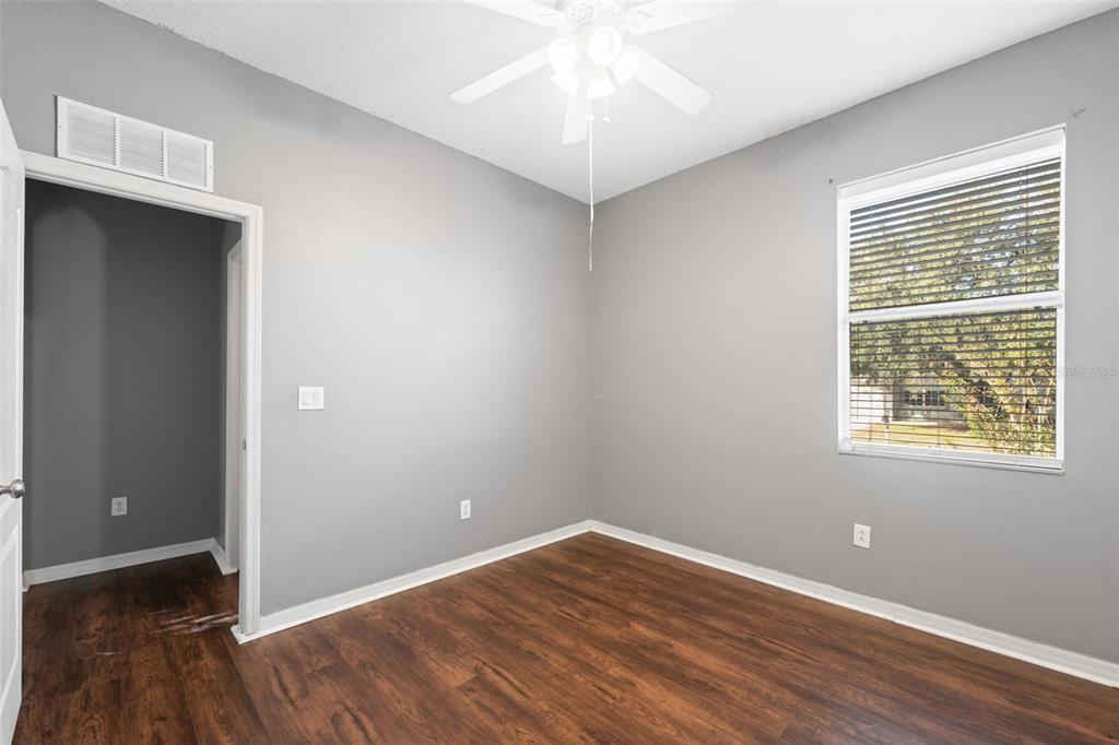 14027 Bensbrook Drive Spring Hill, FL 34609 - Photo 30 of 61 an empty room with wooden floor and windows