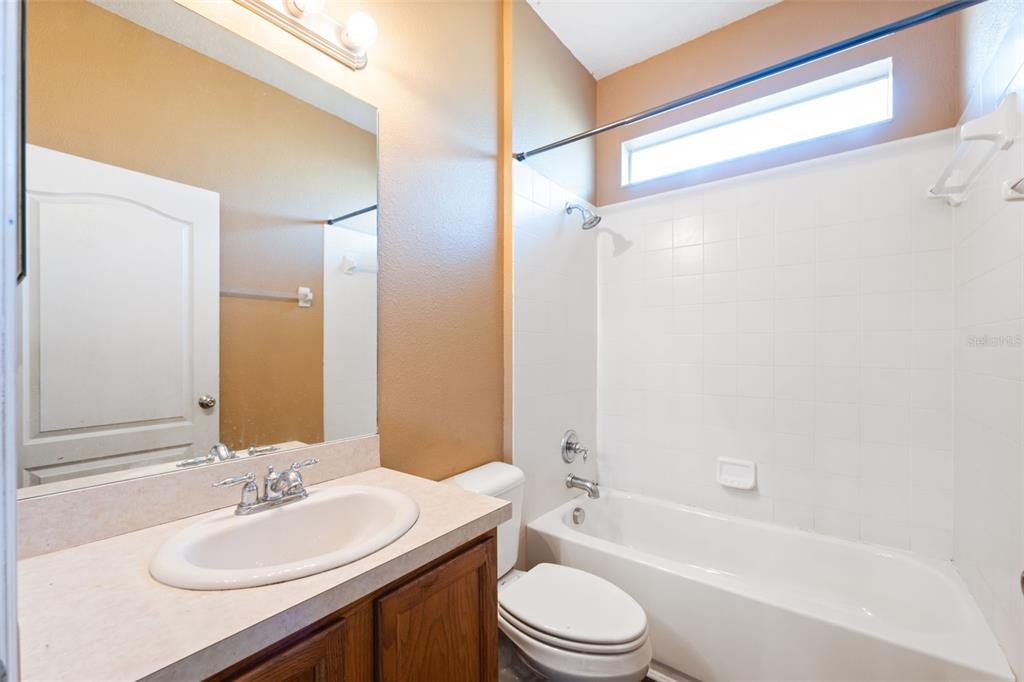 14027 Bensbrook Drive Spring Hill, FL 34609 - Photo 31 of 61 a bathroom with a bathtub shower sink vanity mirror and toilet