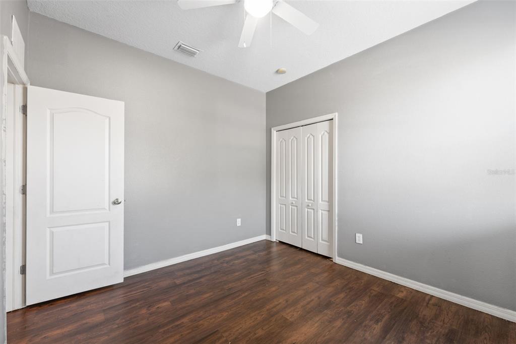 14027 Bensbrook Drive Spring Hill, FL 34609 - Photo 33 of 61 a view of an empty room with wooden floor
