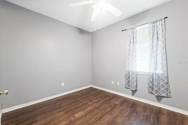 a bathroom with a granite countertop bathtub shower sink vanity mirror and toilet
