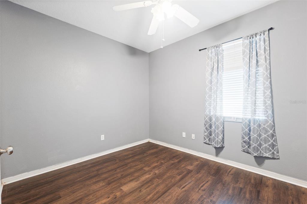 14027 Bensbrook Drive Spring Hill, FL 34609 - Photo 35 of 61 wooden floor in an empty room with a window