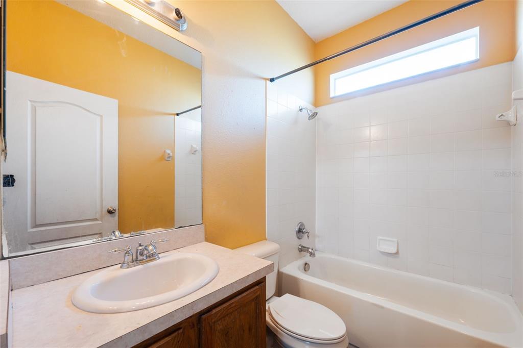 14027 Bensbrook Drive Spring Hill, FL 34609 - Photo 37 of 61 a bathroom with a granite countertop bathtub shower sink vanity mirror and toilet