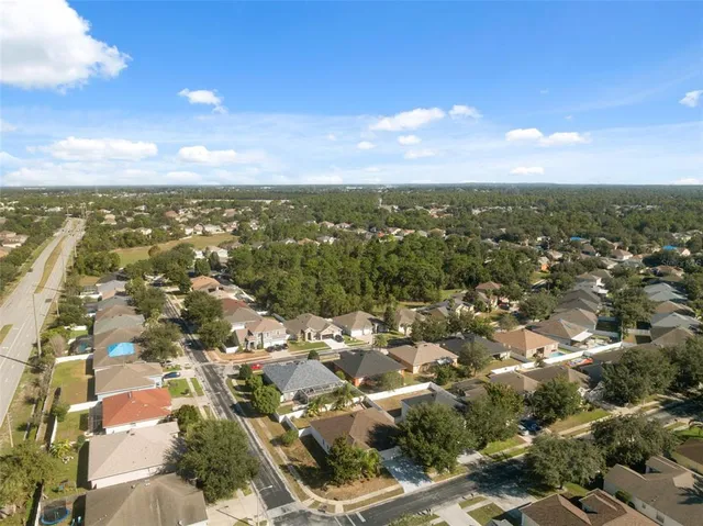 an aerial view of a residential apartment building with a yard