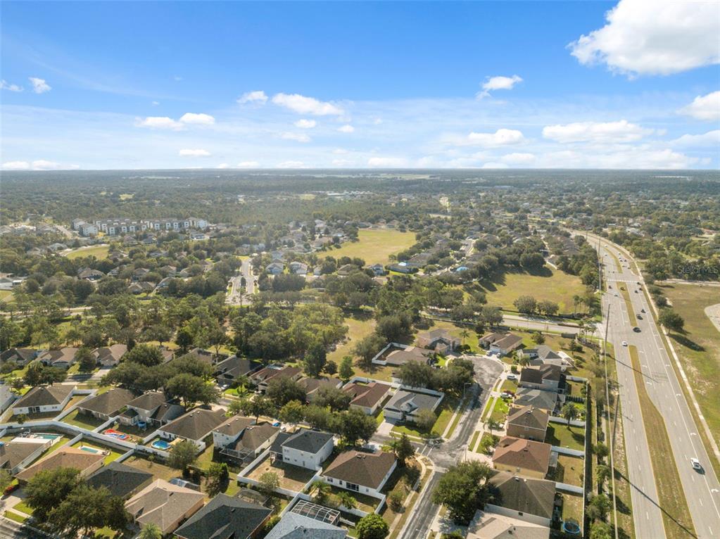 14027 Bensbrook Drive Spring Hill, FL 34609 - Photo 50 of 61 an aerial view of residential building with parking space