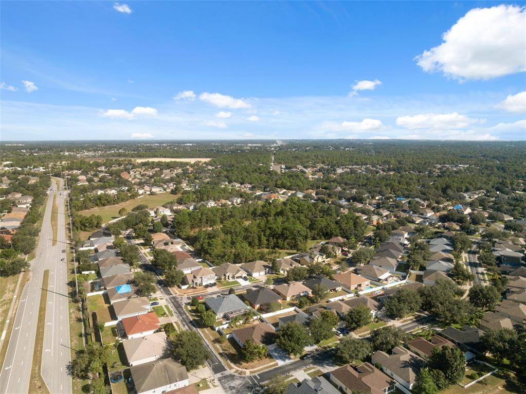 14027 Bensbrook Drive Spring Hill, FL 34609 - Photo 53 of 61 an aerial view of residential building with green space
