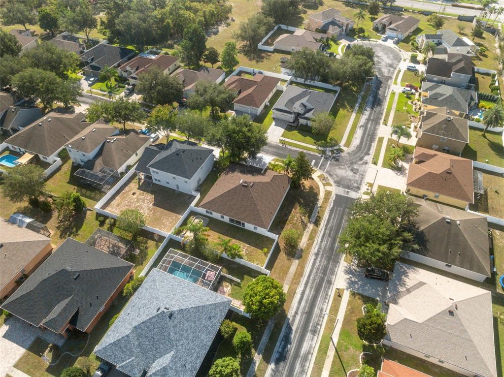 14027 Bensbrook Drive Spring Hill, FL 34609 - Photo 57 of 61 an aerial view of a residential apartment building with a yard