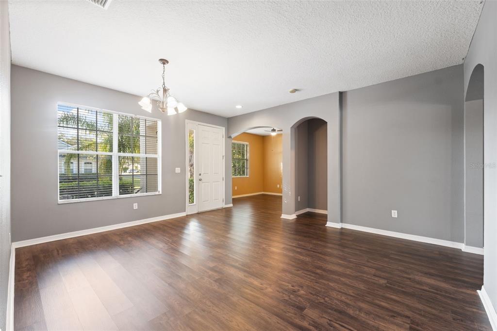 14027 Bensbrook Drive Spring Hill, FL 34609 - Photo 6 of 61 a view of an empty room with wooden floor and a window
