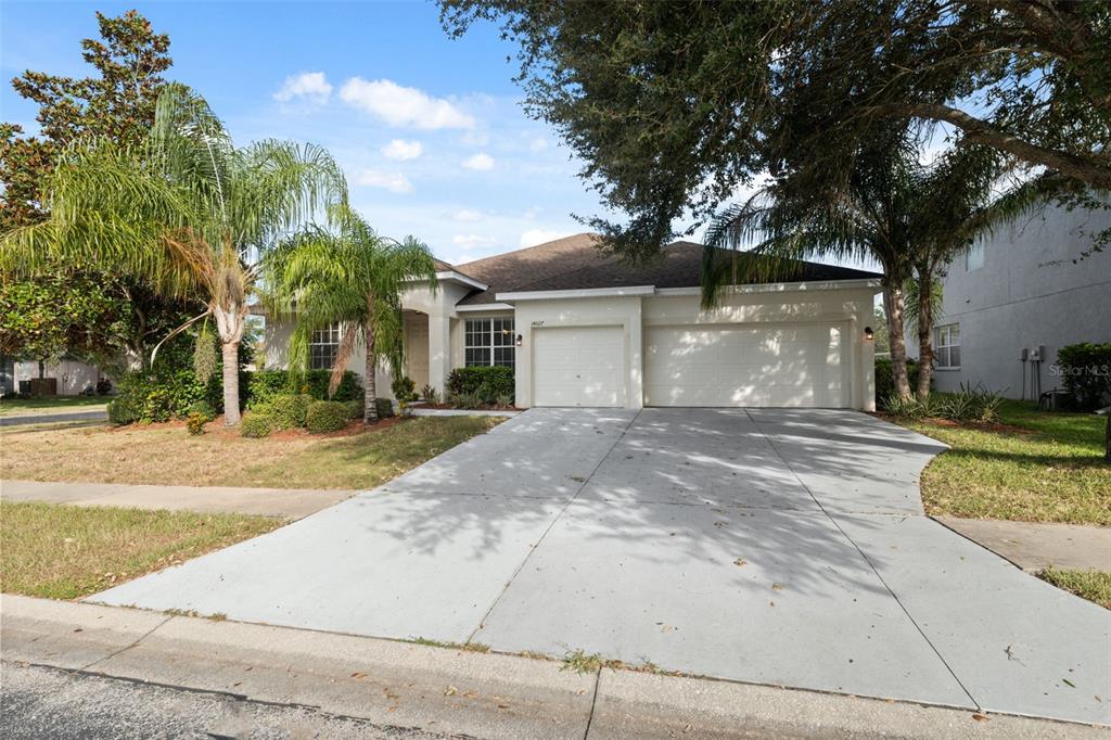 14027 Bensbrook Drive Spring Hill, FL 34609 - Photo 61 of 61 a front view of a house with a yard and potted plants