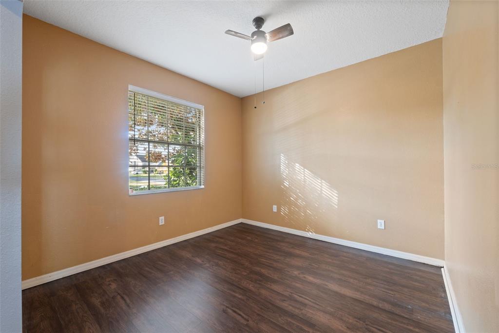 14027 Bensbrook Drive Spring Hill, FL 34609 - Photo 7 of 61 an empty room with wooden floor and windows
