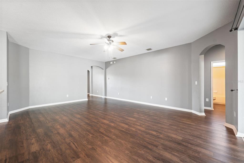 14027 Bensbrook Drive Spring Hill, FL 34609 - Photo 10 of 61 a view of an empty room with wooden floor