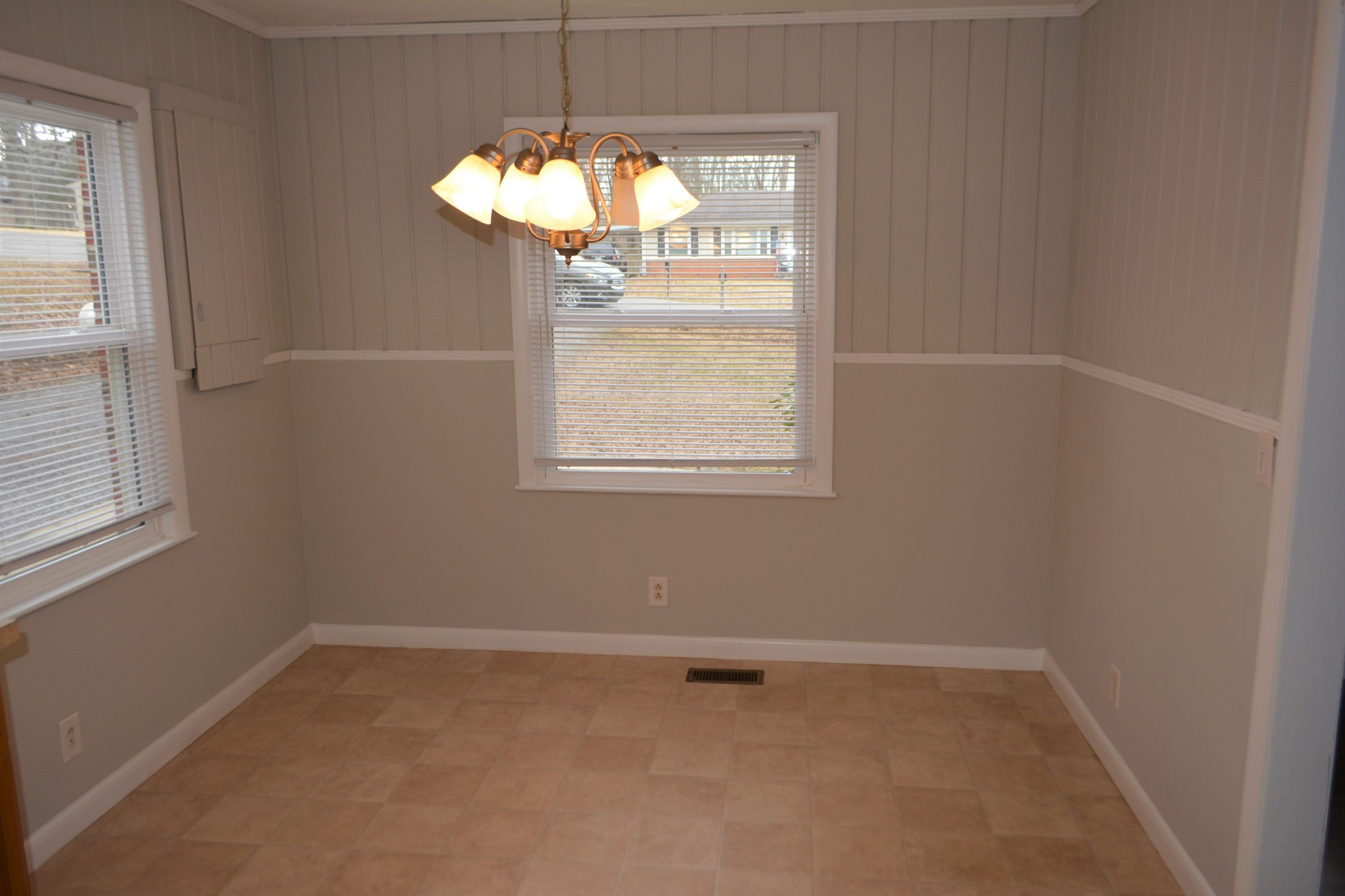 111 Chestnut Street Smyrna, TN 37167 - Photo 7 of 13 an empty room with a chandelier fan and a window