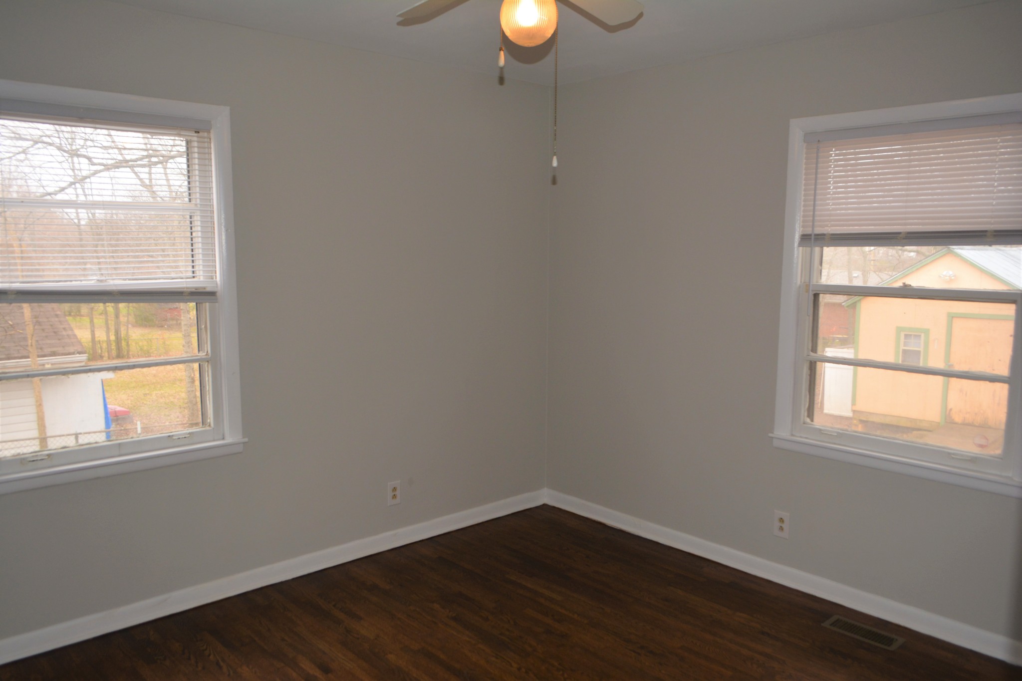 111 Chestnut Street Smyrna, TN 37167 - Photo 9 of 13 an empty room with wooden floor and windows