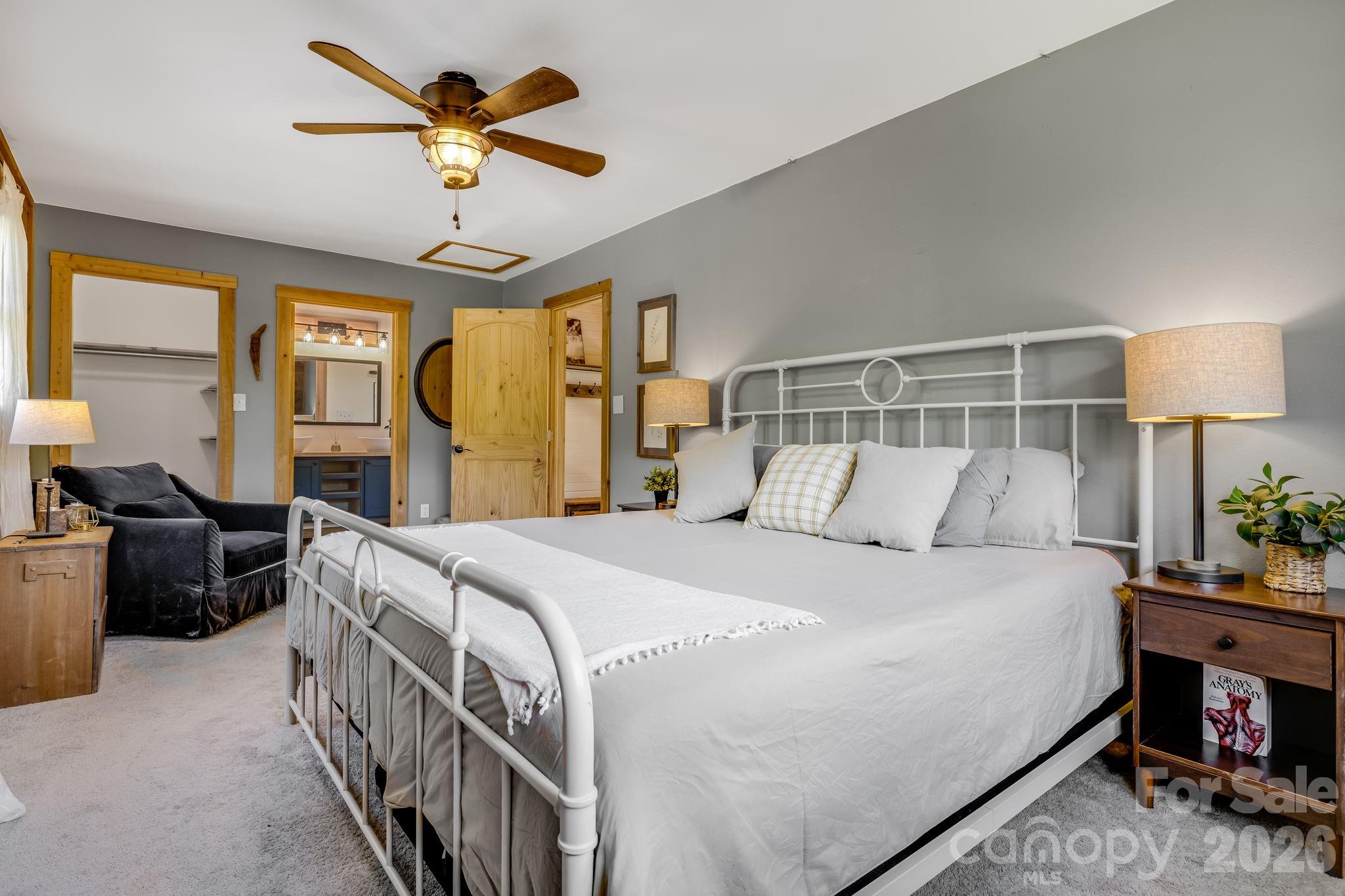 694 Boulder Road Marshall, NC 28753 - Photo 26 of 44 a bedroom with a bed and a chandelier