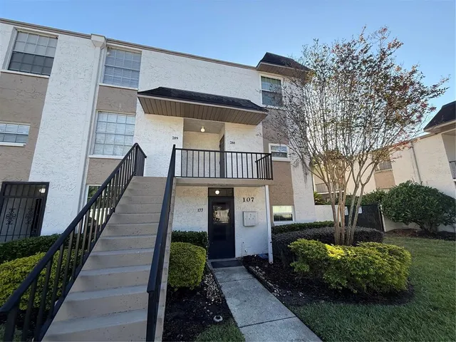 a view of a house with wooden fence