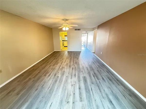 a view of a room with wooden floor