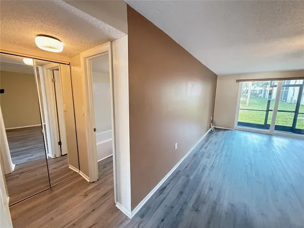 a view of a hallway with wooden floor and stairs