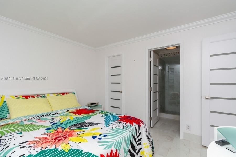 14 Royal Palm Way, Unit 5010 Boca Raton, FL 33432 - Photo 14 of 15 a bedroom with a bed and a closet