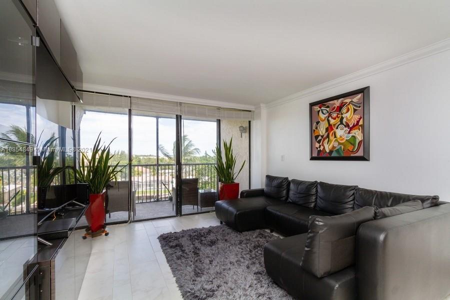 14 Royal Palm Way, Unit 5010 Boca Raton, FL 33432 - Photo 2 of 15 a living room with furniture floor to ceiling window and a flat screen tv