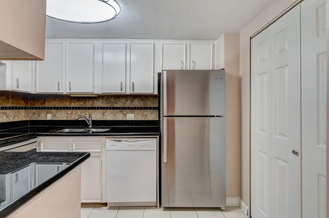 a kitchen with appliances a sink and cabinets