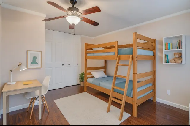 a bedroom with a bunk bed and a desk
