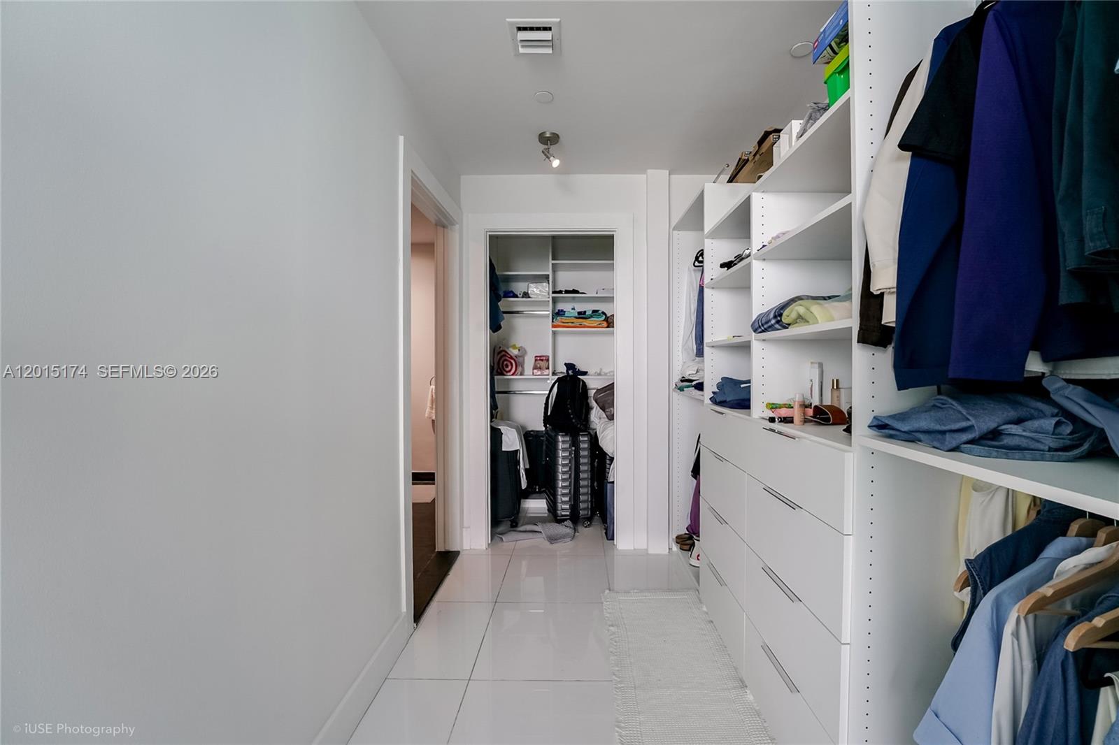 900 Biscayne Boulevard, Unit 3407 Miami, FL 33132 - Photo 11 of 15 a hallway with white cabinets and a window