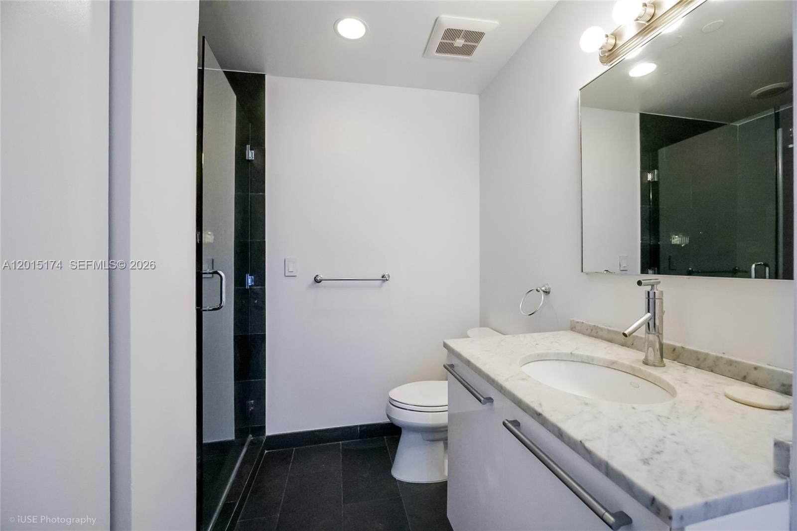 900 Biscayne Boulevard, Unit 3407 Miami, FL 33132 - Photo 12 of 15 a bathroom with a granite countertop sink toilet and shower