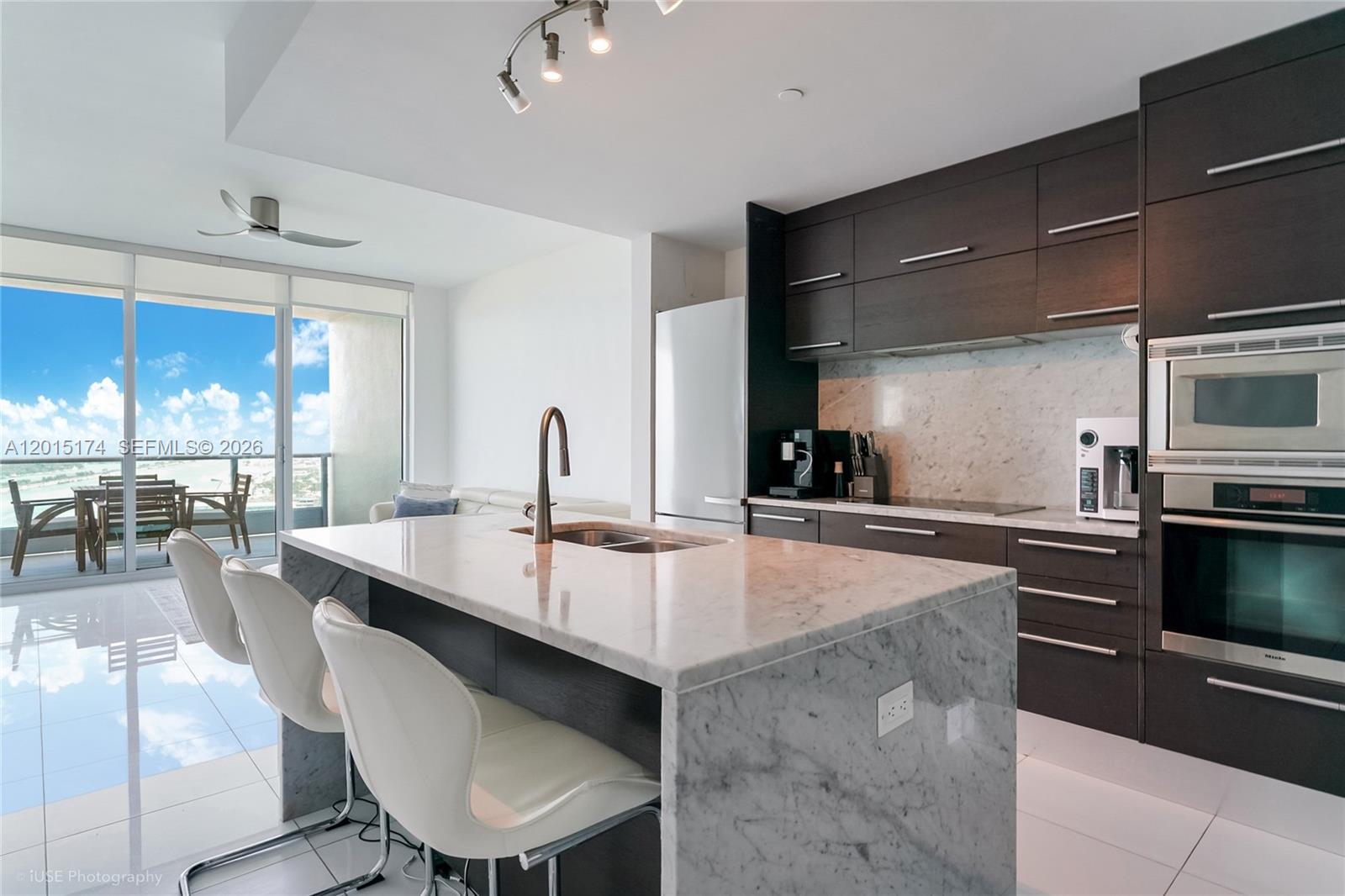 900 Biscayne Boulevard, Unit 3407 Miami, FL 33132 - Photo 2 of 15 a kitchen with a stove a sink and a refrigerator