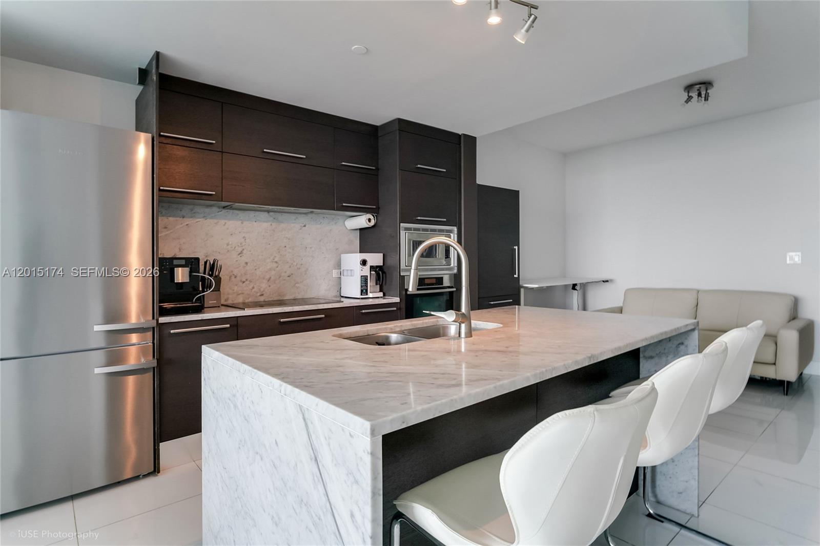 900 Biscayne Boulevard, Unit 3407 Miami, FL 33132 - Photo 3 of 15 a kitchen with appliances cabinets and furniture