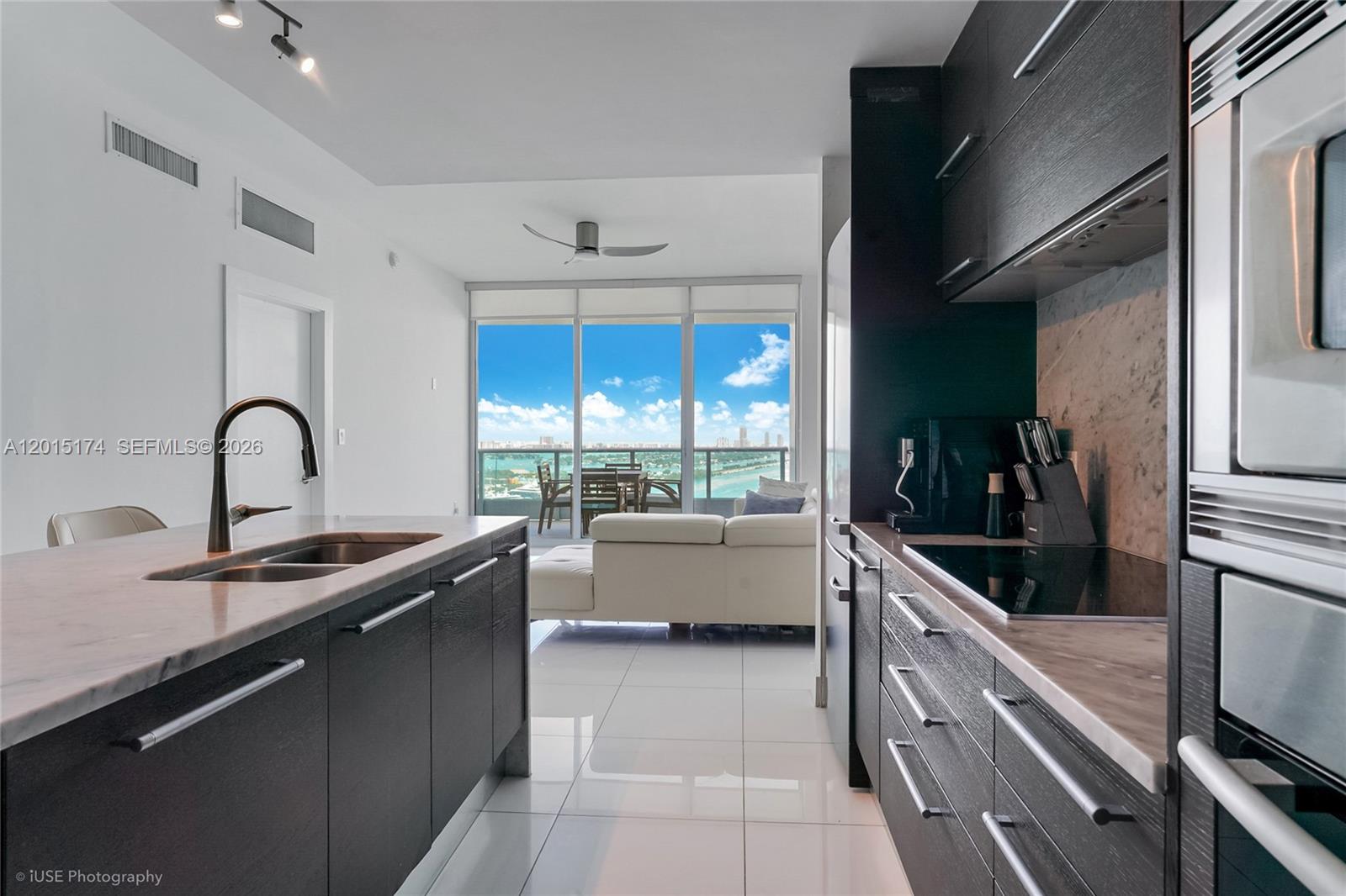 900 Biscayne Boulevard, Unit 3407 Miami, FL 33132 - Photo 4 of 15 a kitchen with counter top space and stainless steel appliances