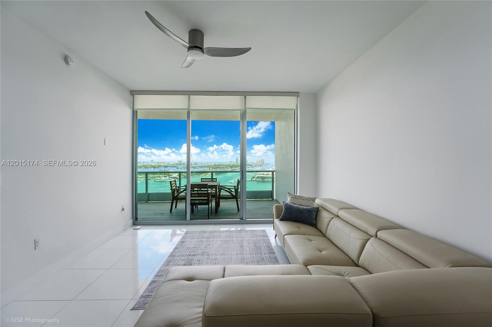 900 Biscayne Boulevard, Unit 3407 Miami, FL 33132 - Photo 6 of 15 a living room with furniture and a floor to ceiling window